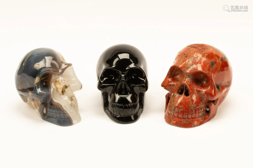 A Set of Three Obsidian, Agate and Red Jasper Skulls