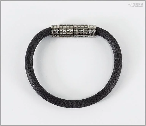 A Louis Vuitton Damier Graphite Digit Bracelet.