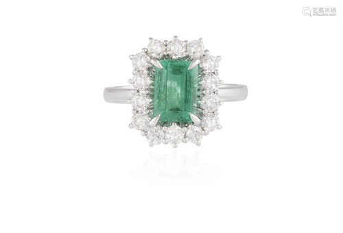 AN EMERALD AND DIAMOND CLUSTER RING Composed of a