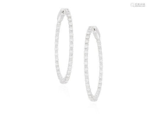 A PAIR OF DIAMOND HOOP EARRINGS Each hoop set with a