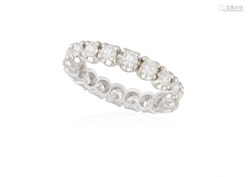 A DIAMOND ETERNITY RING Composed of a continuous row of