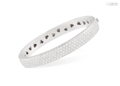 A DIAMOND BANGLE The hinged bangle set with