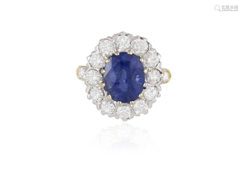 A SAPPHIRE AND DIAMOND CLUSTER RING The oval-shaped