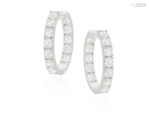 A PAIR OF DIAMOND HOOP EARRINGS Each oval hoop set with