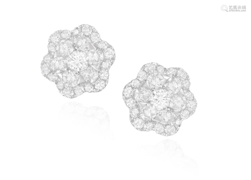 A PAIR OF DIAMOND EARSTUDS Each composed of flower…