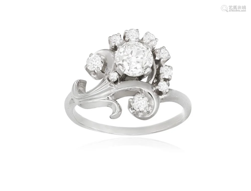 A DIAMOND DRESS RING Of scrolling design, the central