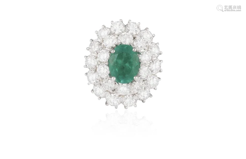 AN EMERALD AND DIAMOND CLUSTER RING Composed of a