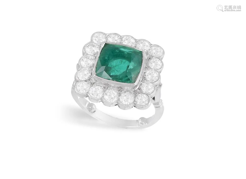 AN EMERALD AND DIAMOND CLUSTER RING The cushion-shaped