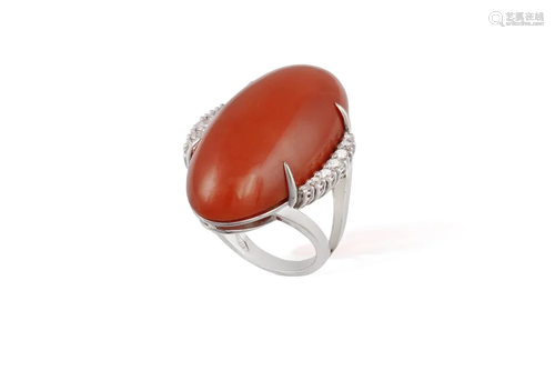 A CORAL AND DIAMOND COCKTAIL RING The large oval-shaped