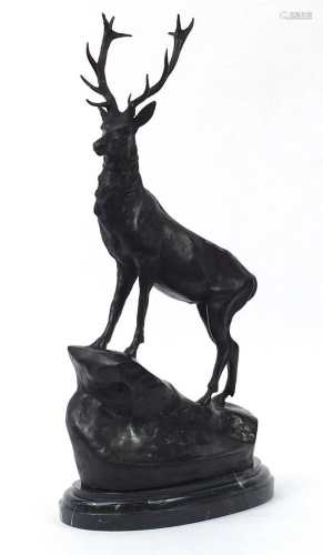 Large patinated bronze stag raised on a shaped marble