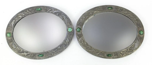 Manner of Liberty & Co, pair of Arts & Crafts oval wall