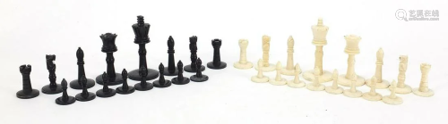 Carved bone half stained chess set, the largest pieces