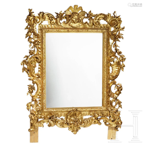 A large mirror with sumptuous gilt frame in