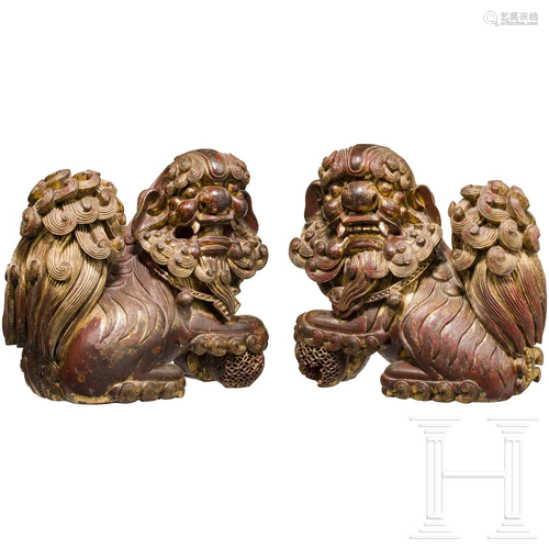 A pair of finely carved Chinese wooden fo-lions,