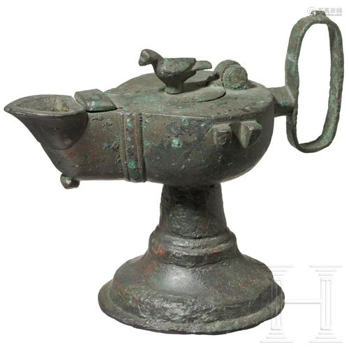 A Byzantine bronze oil lamp, 5th - 7th century