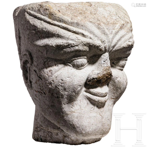 An Italian limestone capital in the shape of a head,