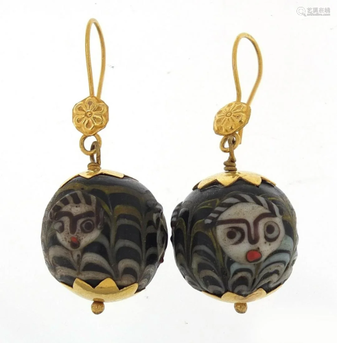Pair of Islamic unmarked gold mounted glass earrings,