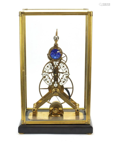 Gothic style brass skeleton clock with moon face dial