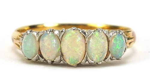 Unmarked gold graduated opal five stone ring, tests as