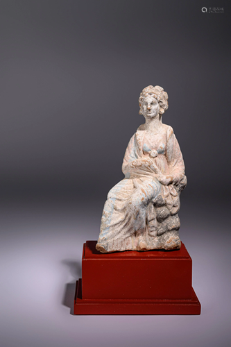 A Greek Terracotta Seated Woman Height 7 1/2 inches.