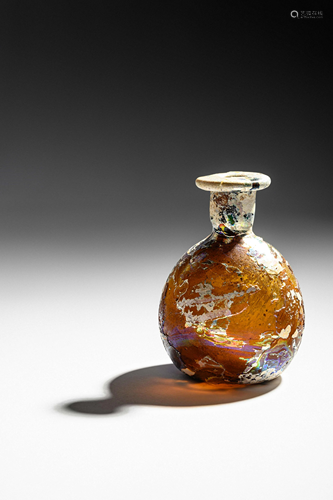 A Roman Amber Glass Flask Height 3 3/4 inches.