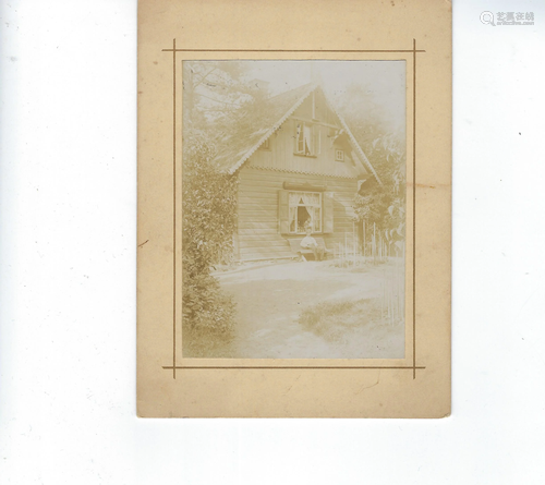 Photo of wood cottage on cream mat