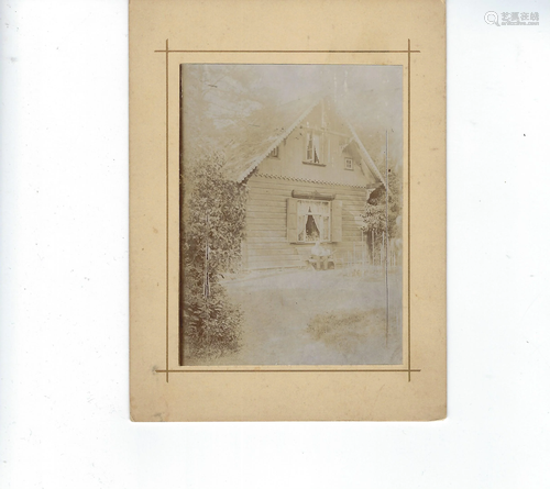 Photo of a wood cottage on cream mat