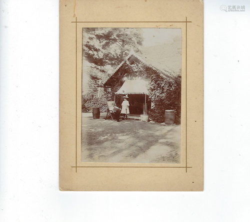 Photo of man and little girl in front of a wood cottage