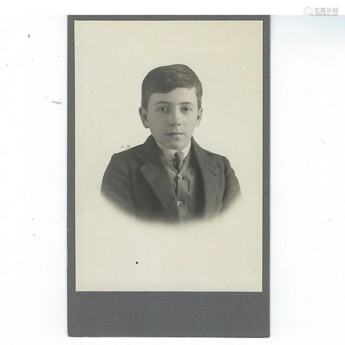 Photo of a young boy in suit, glued down on gray card