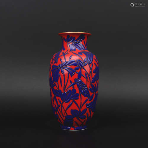 A red glazed 'floral' vase