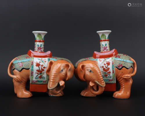 A pair of enamel elephant candlestick