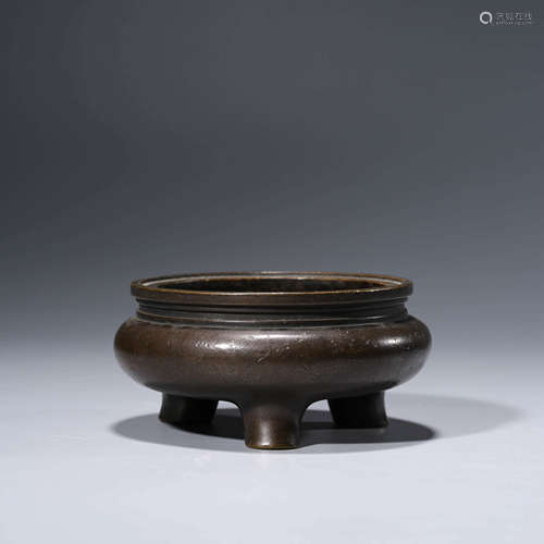 A bronze tripod incense burner