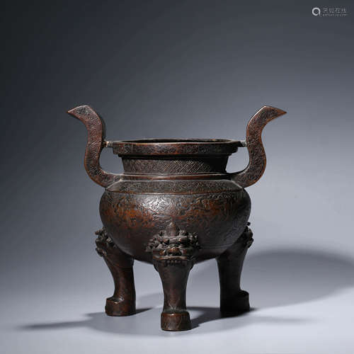 A bronze dragon and phoenix tripod censer