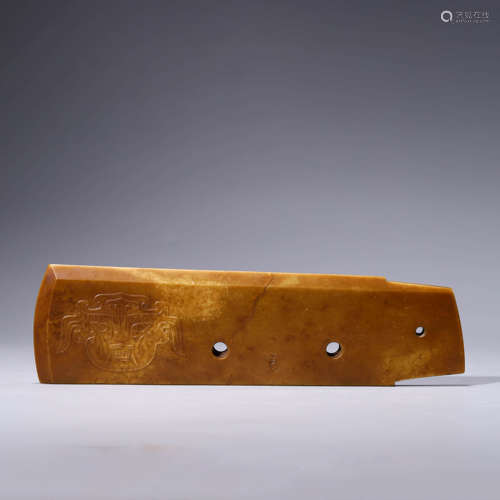 A carved brownish jade blade gui