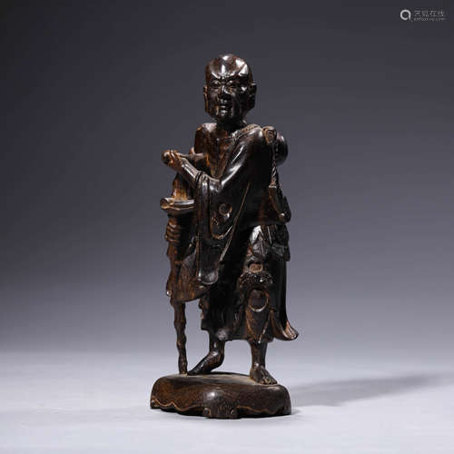 A carved wood figure statue