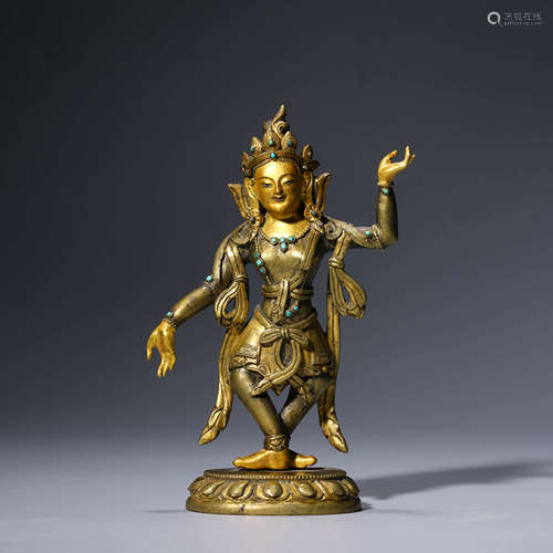 a gilt-bronze statue of buddha