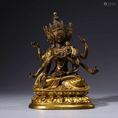 A gilt-bronze statue of three-faced and eight-armed buddha