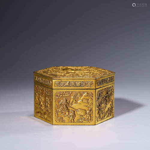 A gilt-bronze hexagonal figure box and cover