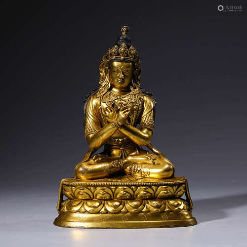 a gilt-bronze statue of buddha