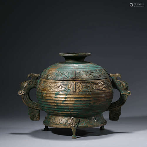 An archaistic bronze dragon tripod food vessel