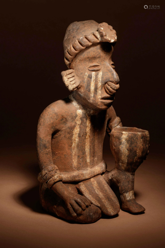A Nayarit Terracotta Crouching Figure with Vessel