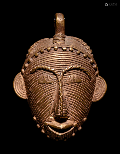 A Baule or Akan Gilt-Metal Pendant Height 2 1/2 inches.