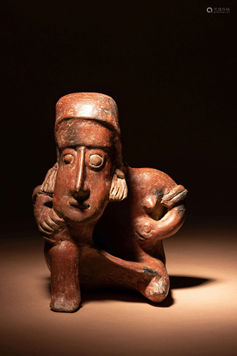 A Colima Terracotta Seated Male Figure Height 10 1/2