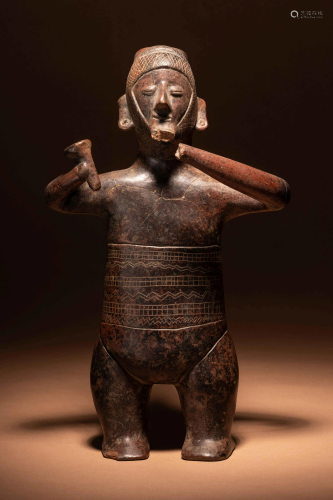 A Colima Terracotta Standing Male Figure with Incised