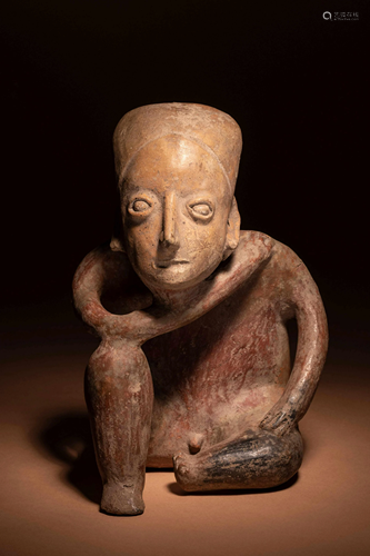 A Colima Terracotta Kneeling Figure Height 9 inches.