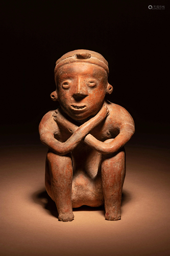 A Colima Terracotta Squatting Figure Height 8 1/2