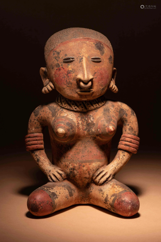 A Nayarit Terracotta Seated Female Figure Height 13 1/4