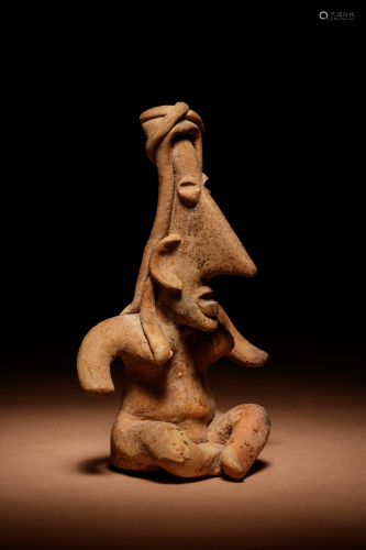 A Jalisco Terracotta Seated Figure Height 5 inches.