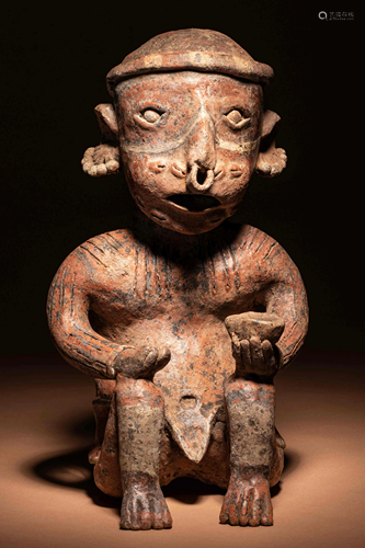 A Nayarit Seated Male Figure Height 12 inches.