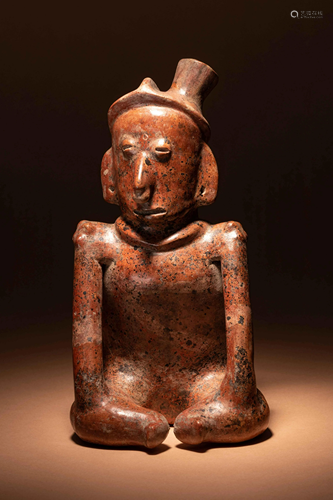 A Colima Terracotta Seated Figure Height 10 inches.